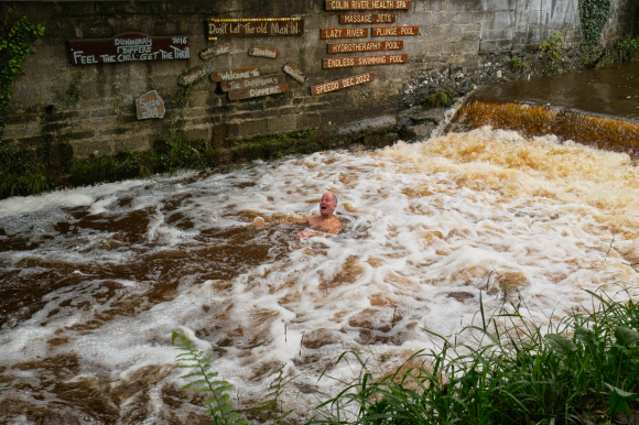 man taking bath in a canal