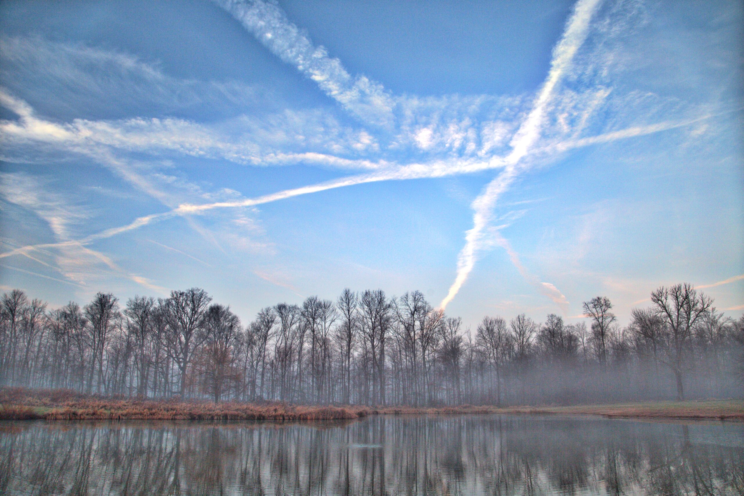 hazy lake with blue skies