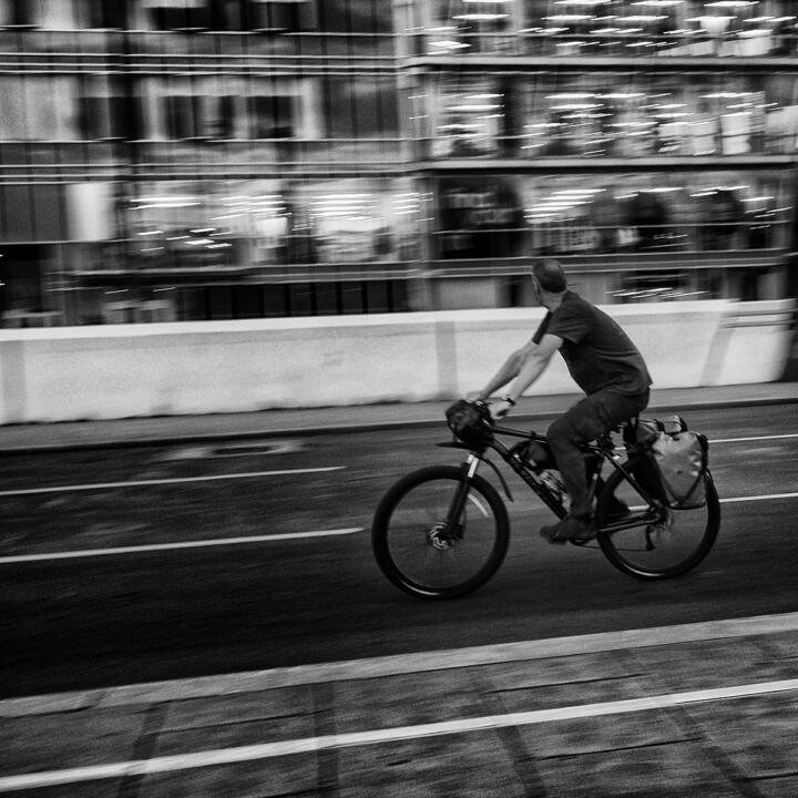 black and white cyclist shot