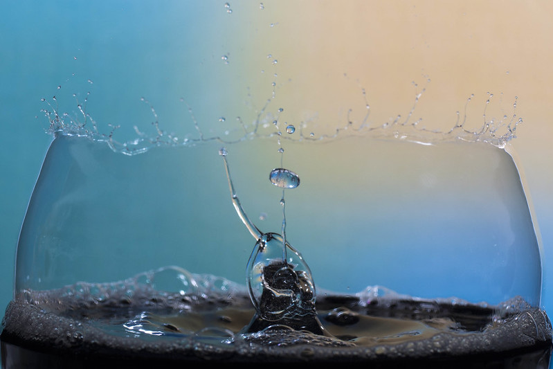 Water drop collision inside a bursting soap bubble