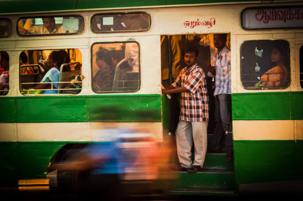 Passengers on a speeding bus in Chenna, India 