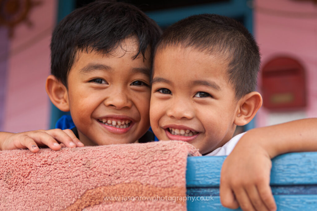 Two babies from Brunei smiling at the camera