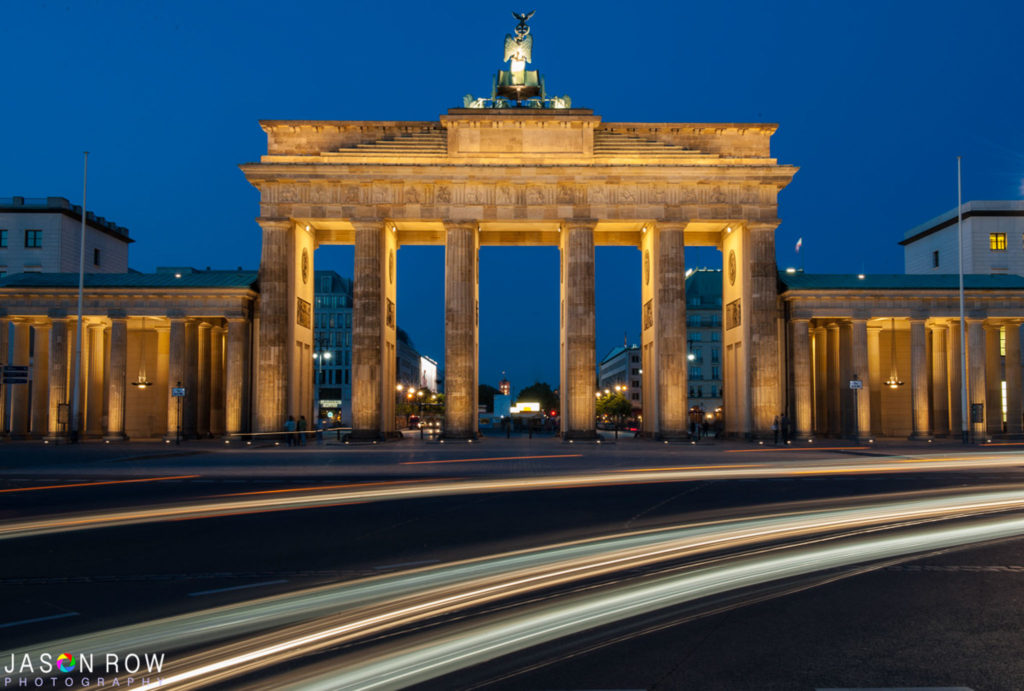 Car light trails streak in front of the Brandenburg Berlin