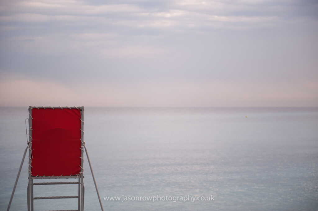 A red, empty lifeguard chair looks out to sea in Nice, France 