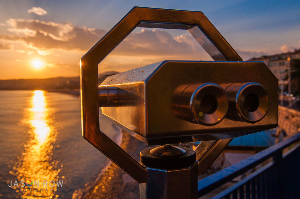 Tourist binoculars overlooking Nice at sunset