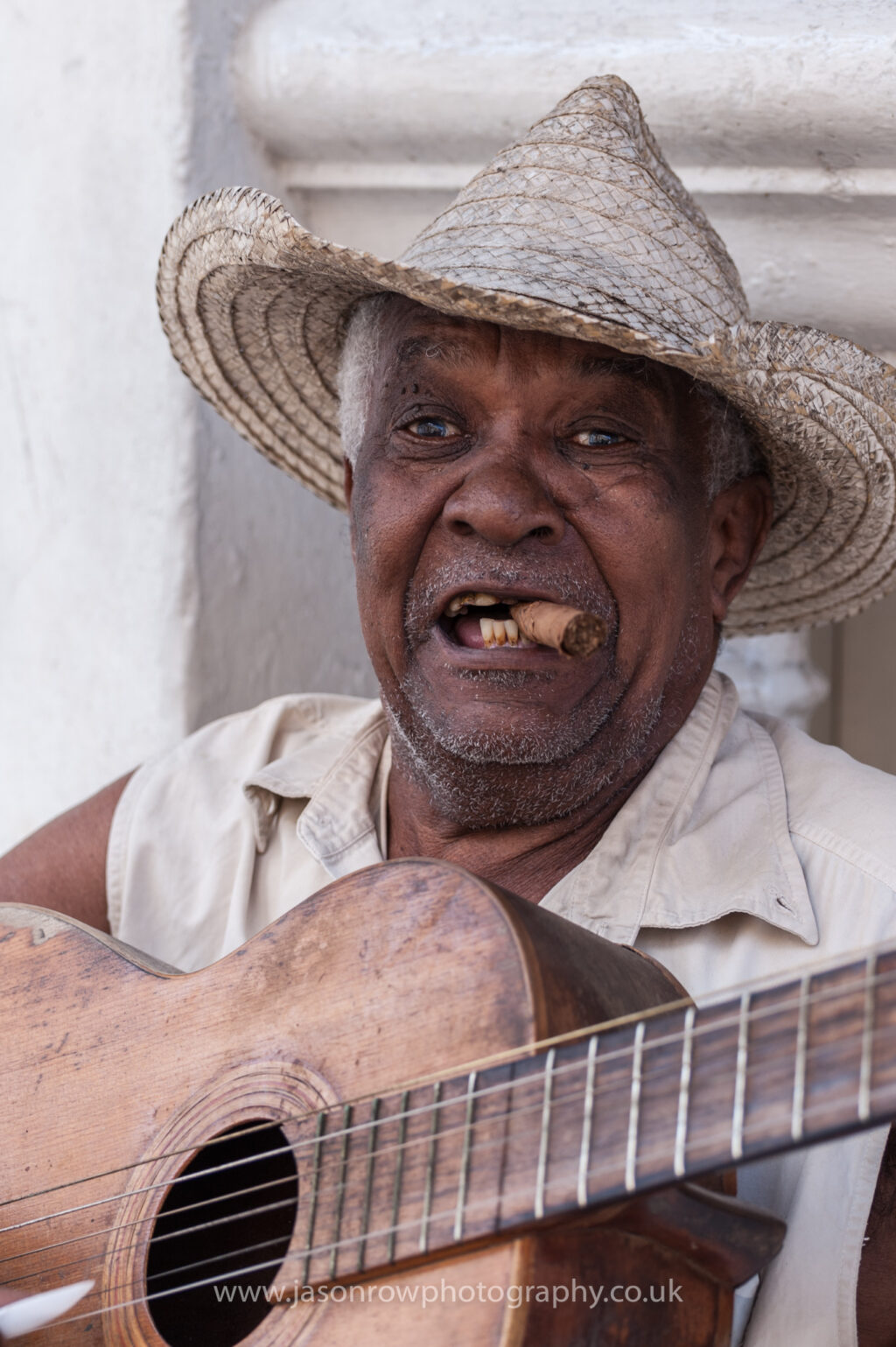A Cuban street musician plays guitar in Santiago