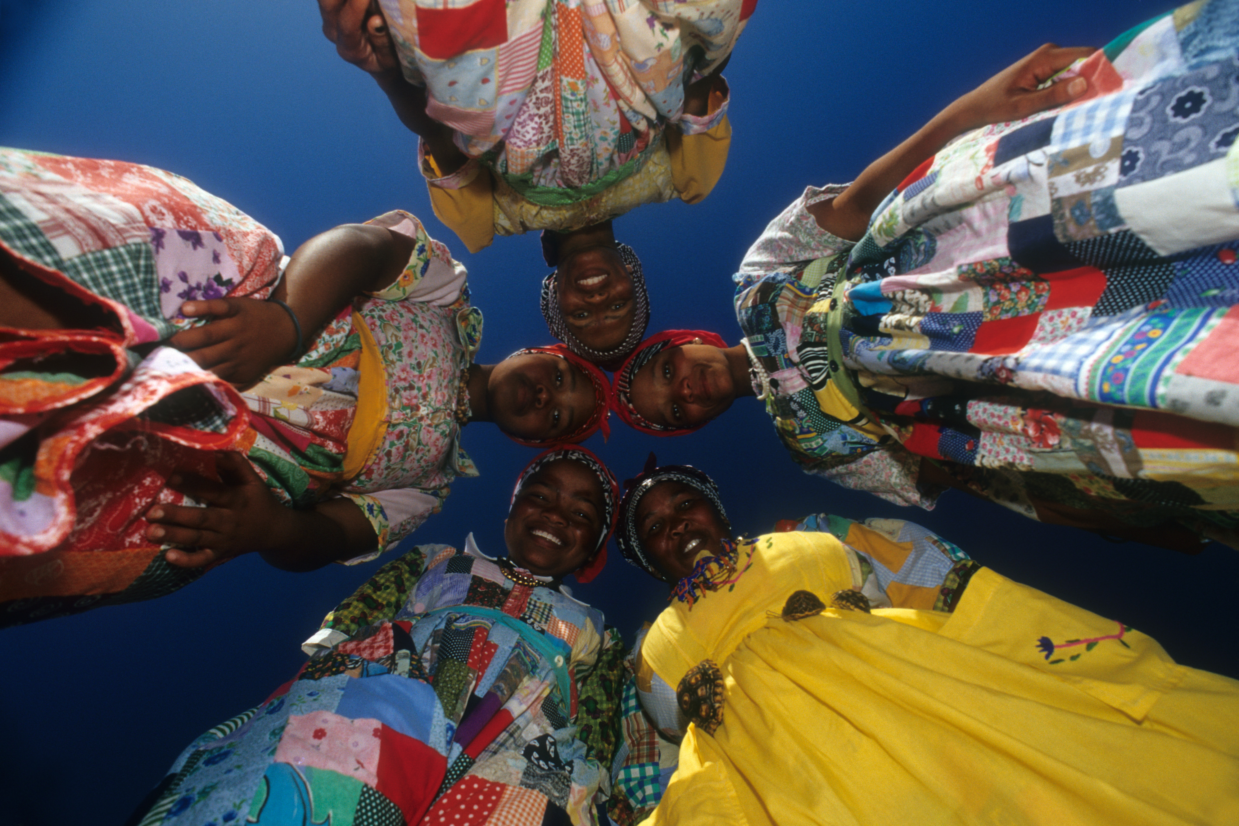 The expressive faces of the Namib Herero people are seen from a fresh perspective. As the photographer shot lying on the ground he was composing a totally unique image. Note that no matter which way you turn this image, it's always right side up.- Peter Guttman