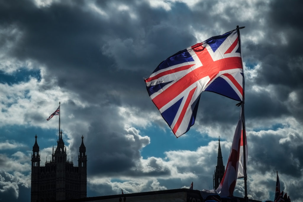 Union Flag with parliament behind on a stormy afternoon