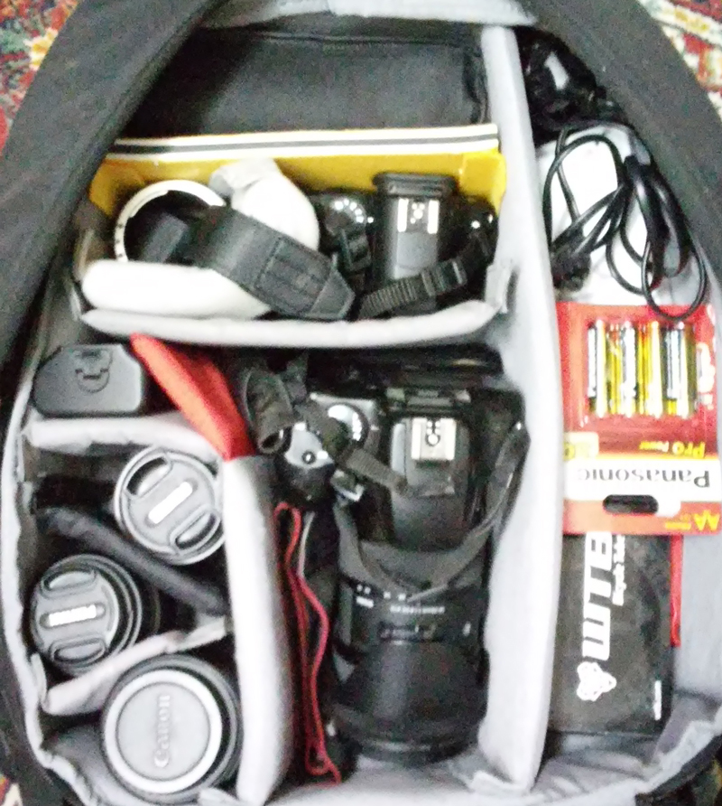 This is how the backpack looked like when I prepared it for the trip. On the left side you can see the lenses for the Pentax and the Canon DSLRs. In the middle is my trusty old Canon EOS 1000D with the Sigma 18-35 mounted on it. Above the Canon lies the Pentax K-50, left of it are the macro tubes, and right above it is the Yongnuo YN-565 EXII flash. On right side, Sanyo battery charger, the chargers for the both cameras, spare bicycle tube, tools for changing the bicycle tube. In the compartment which isn't in the picture (sorry about that) there is a spare battery for the Canon, notepad, pens, tripod shoe, lens cleaning cloth, and the waterproof tent.