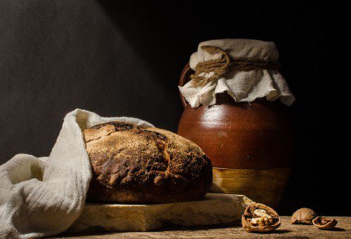 a loaf of bread next to a pile of cookies