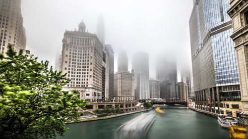 a body of water with buildings in the background