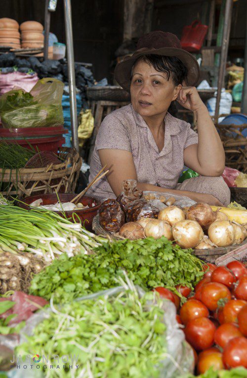 Vietnamese woman seeling fruit in a Danang Market