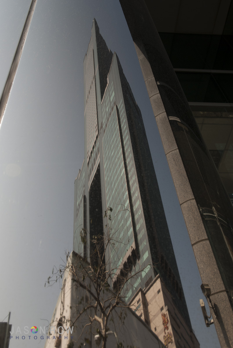 Tower 85 in Kaohsiung reflected in the metal of another building. By Jason Row Photography