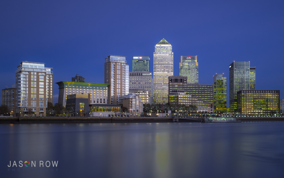 City lights reflected in moving water. By Jason Row Photography