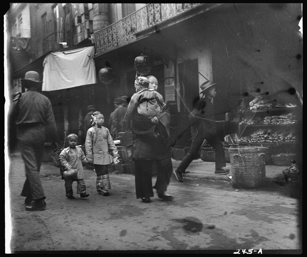 Woman and children walking down a street, Chinatown, San Francisco