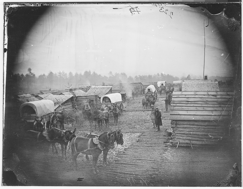 Camp scene showing winter huts and corduroy roads