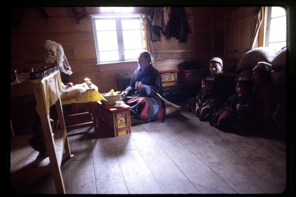 Family of sick girl with Poh, a shaman, during a religious ritual to heal the child