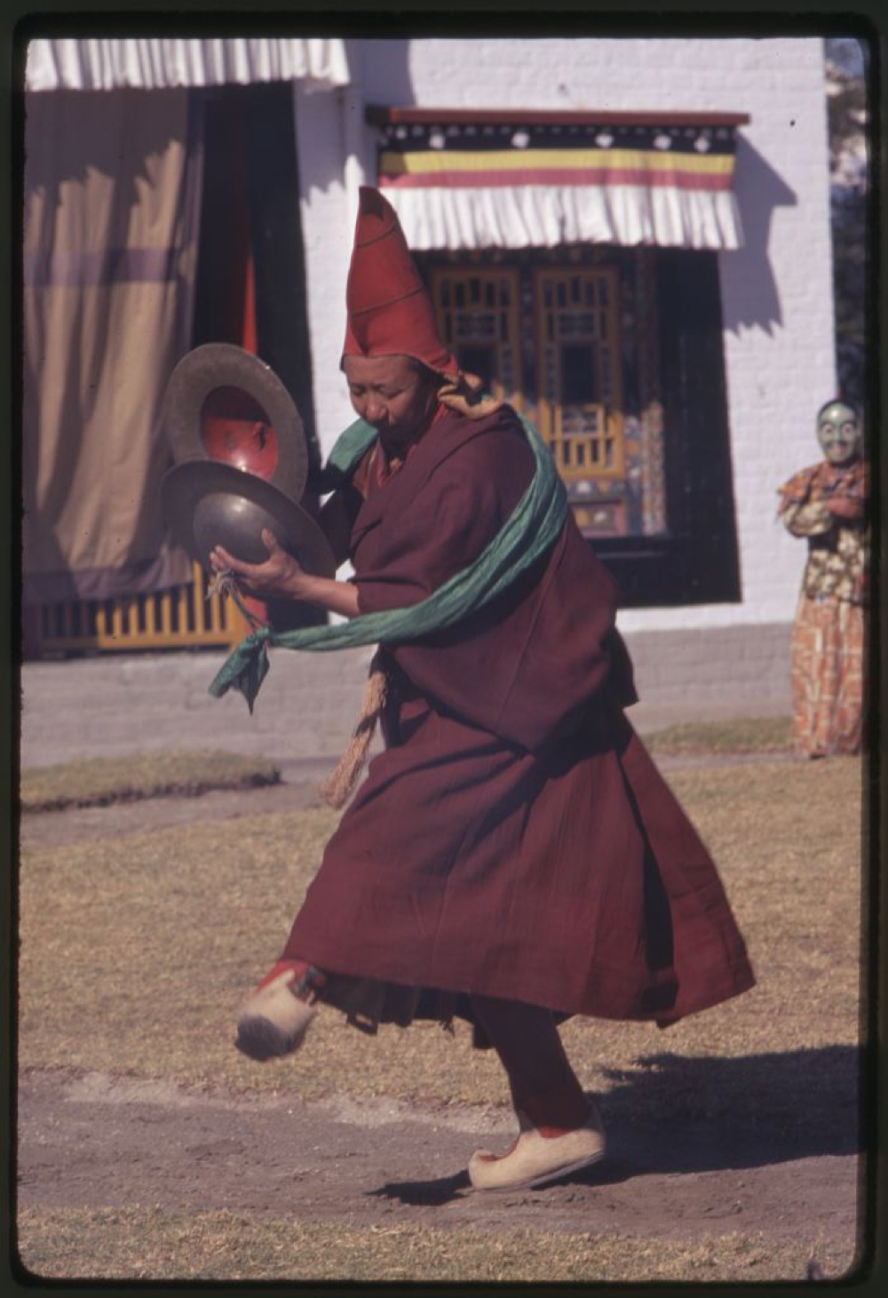Musician lama during ceremonial dances using cymbals