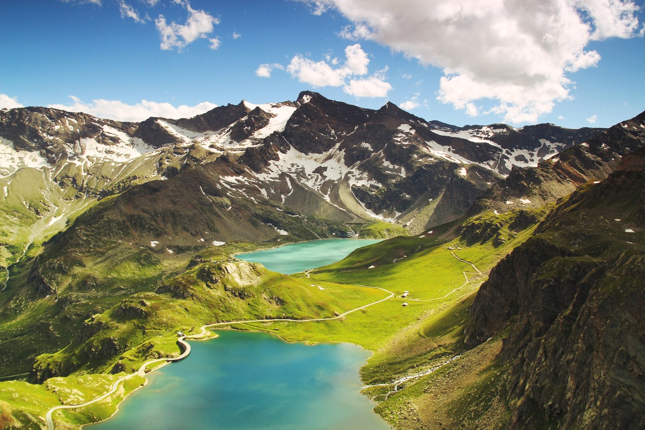 This Photo by Daniel Nanescu uses the road and building to give a sense of scale to the mountains.