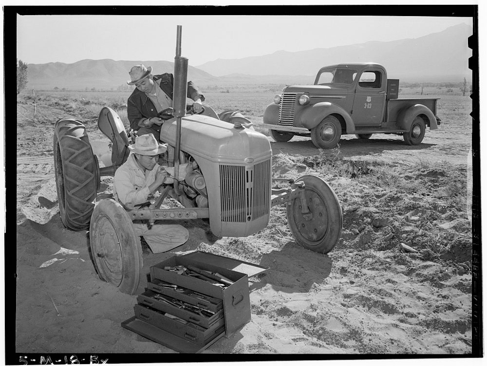 Tractor repair: Driver Benji Iguchi, Mechanic Henry Hanawa, Manzanar Relocation Center, California