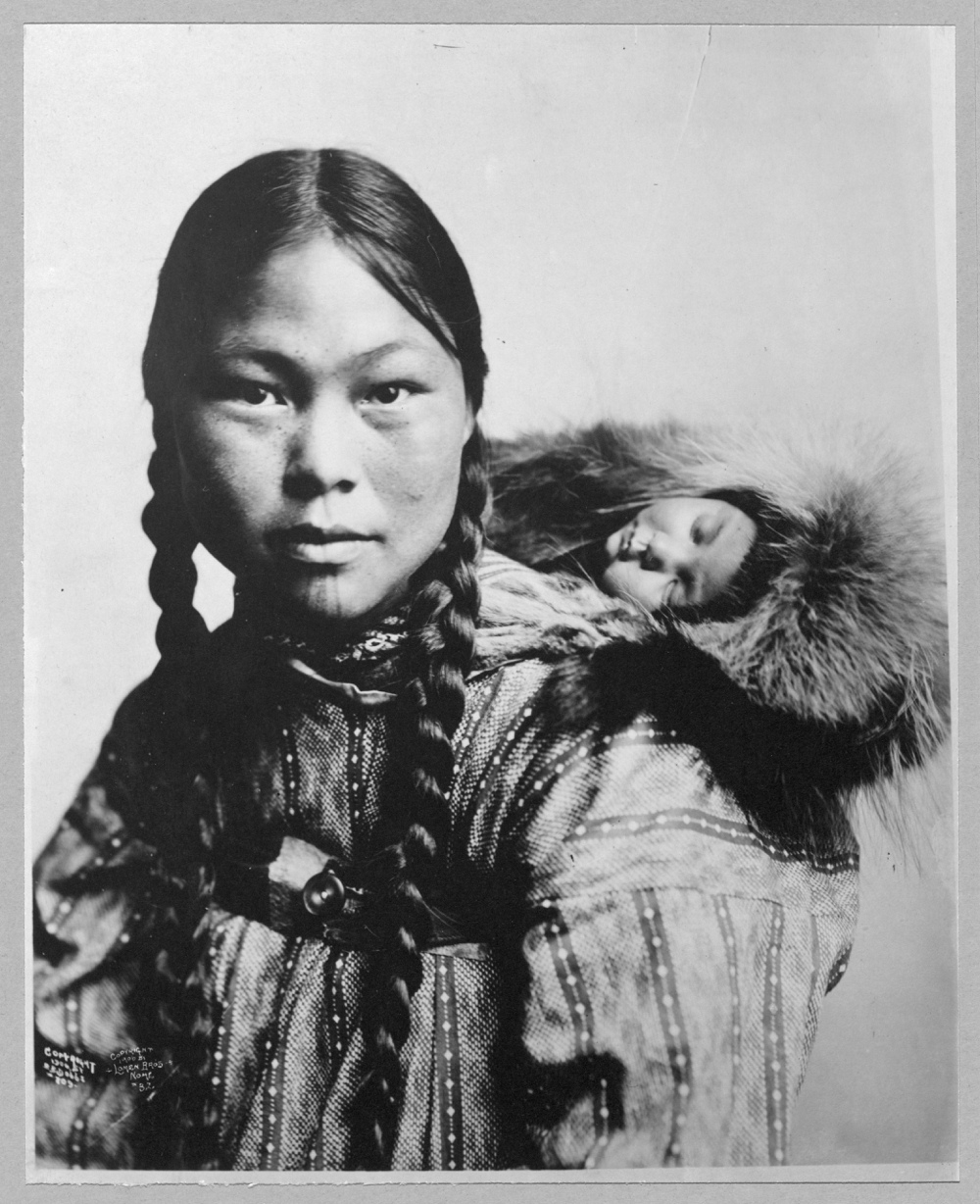 Eskimo mother with child on back