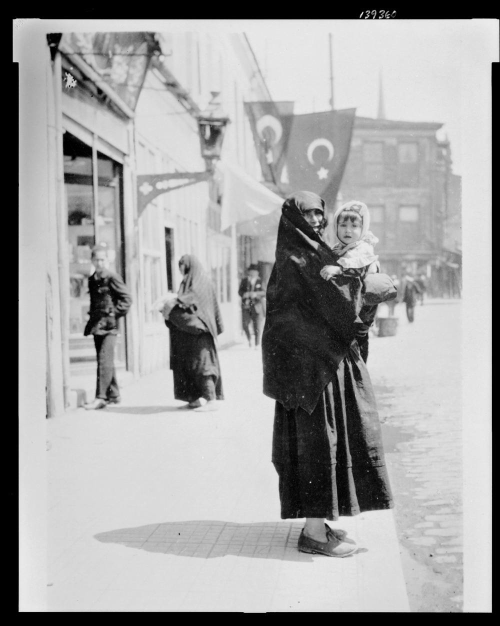 Woman holding a baby on a street in Istanbul