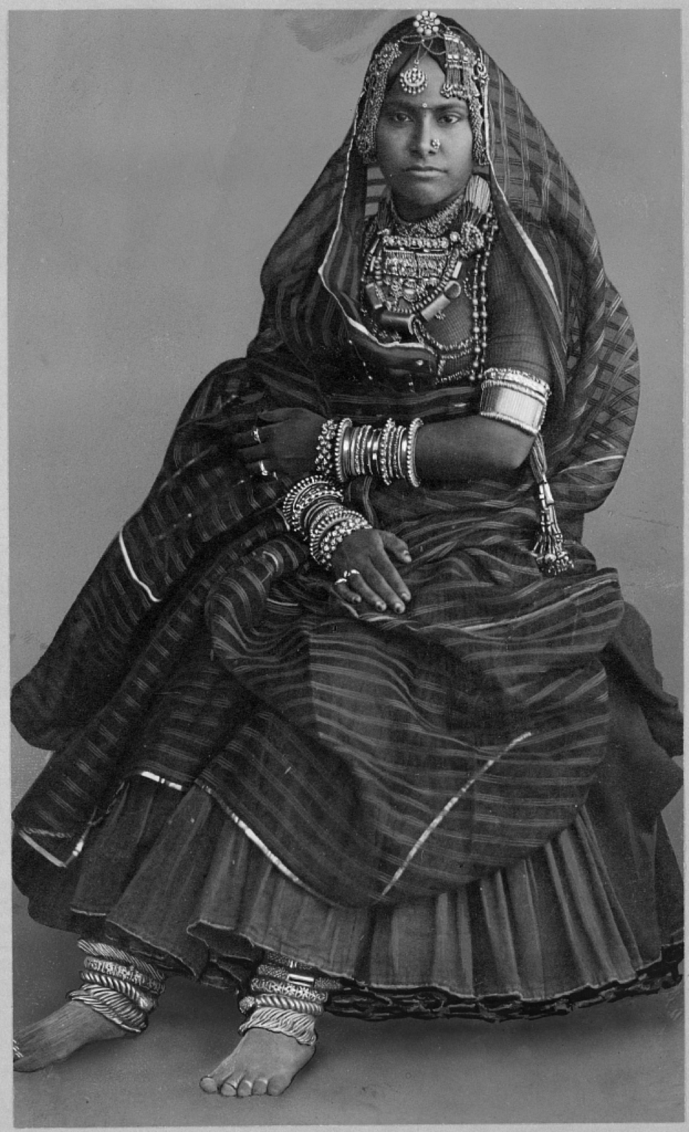 Woman wearing court dress and Indian jewelry