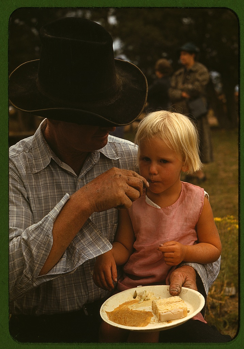 Homesteader feeding his daughter at the Pie Town