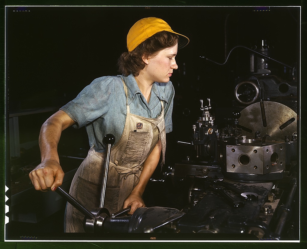 Lathe operator machining parts for transport planes at the Consolidated Aircraft Corporation plant