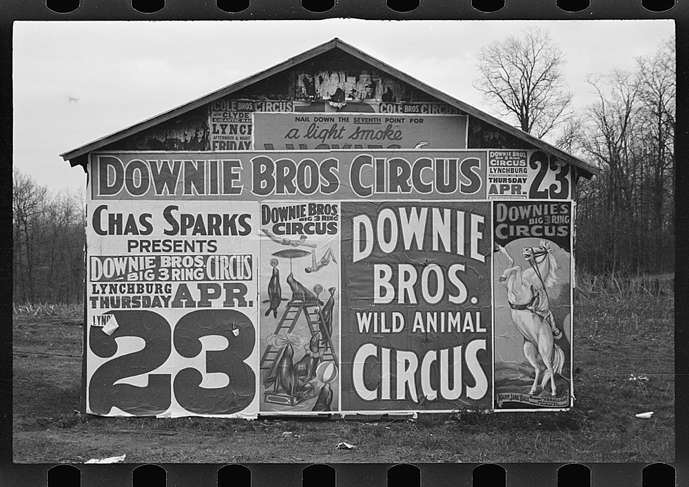 Posters covering a building near Lynchburg to advertise a Downie Bros