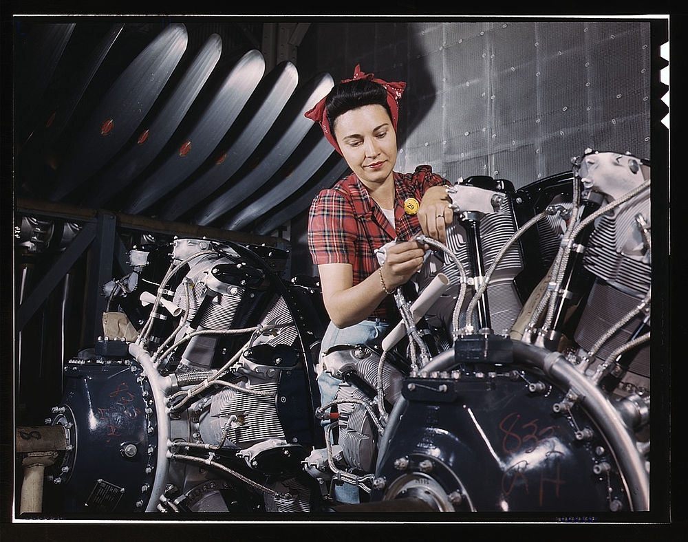 Woman working on an airplane motor at North American Aviation