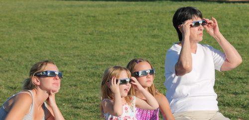 Excited amateur scientists viewing the 2012 May 20 Annular Eclipse in Albuquerque, NM, USA. They are using colored filter glasses provided by the University of New Mexico Department of Physics and Astronomy.