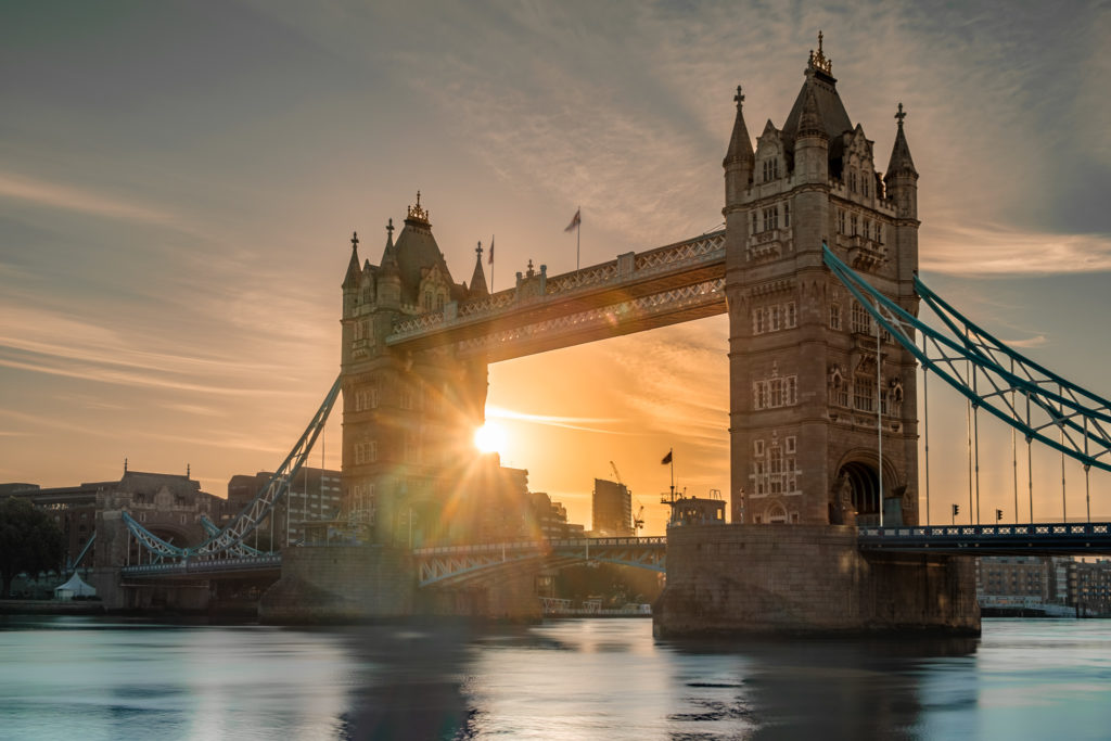 Sun rises behind Tower Bridge in London