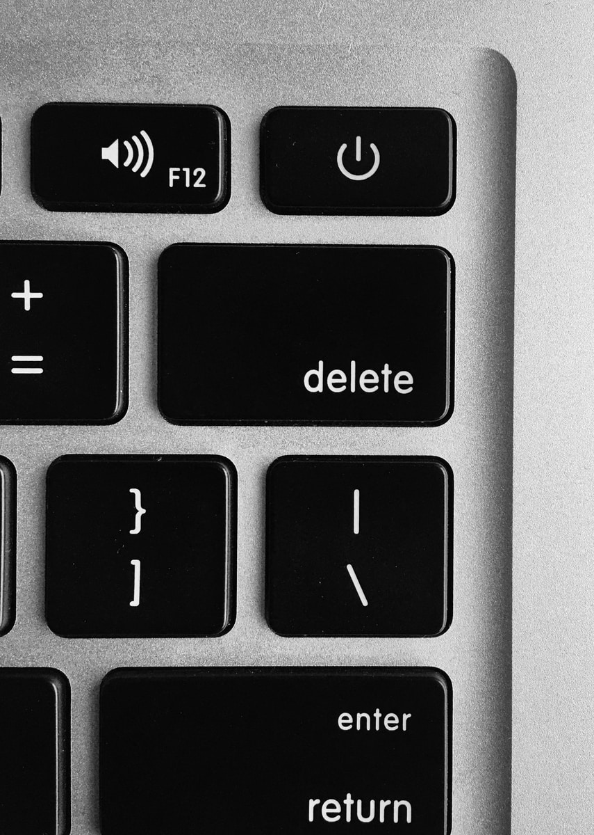 selective focus photo of black and white delete, enter, power button, and F12 computer keys