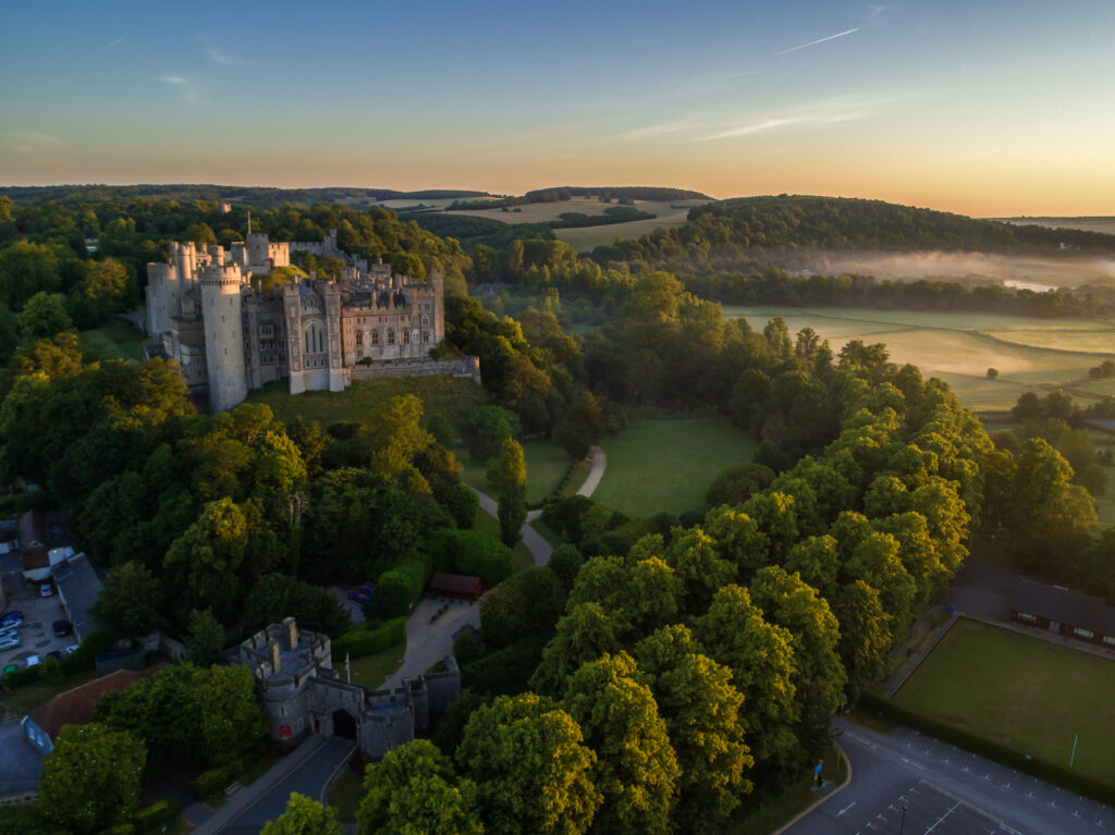 Drone image of Arundel Castle in the golden light of a summer dawn