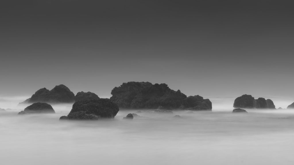 a group of rocks in the water