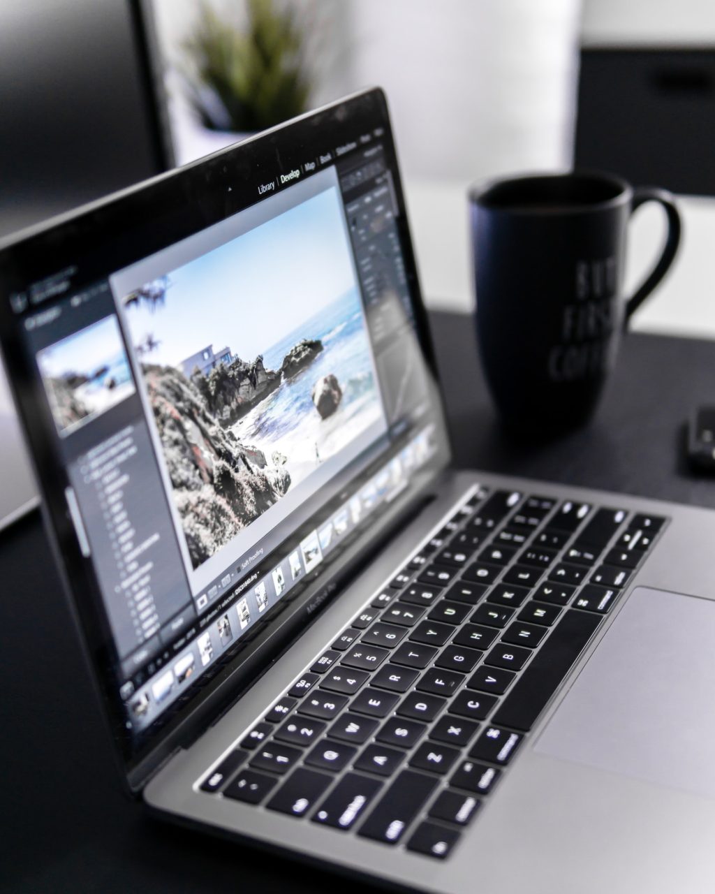 a laptop with a coffee mug on the screen