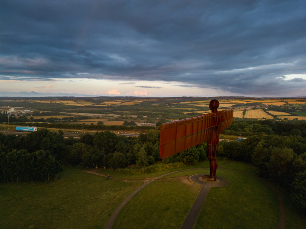 Angel of the North in Newcastle at dawn with the A1 Motorway behind