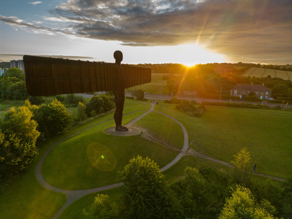 Angel of the North in North East England as the sun rises behind one wing