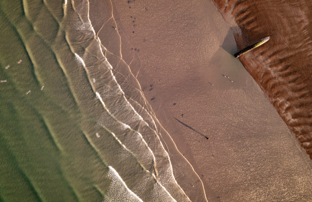 Top down aerial view of Brighton Beach returning to drone photography