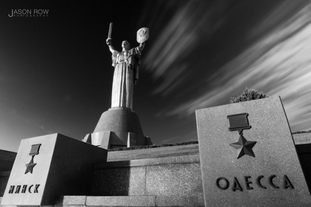 Dramatic film noir style ultra wide shot of the Motherland Statue in Kyiv at Dawn