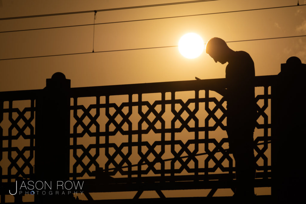 Silhouette of man on Galata Bridge at sunset