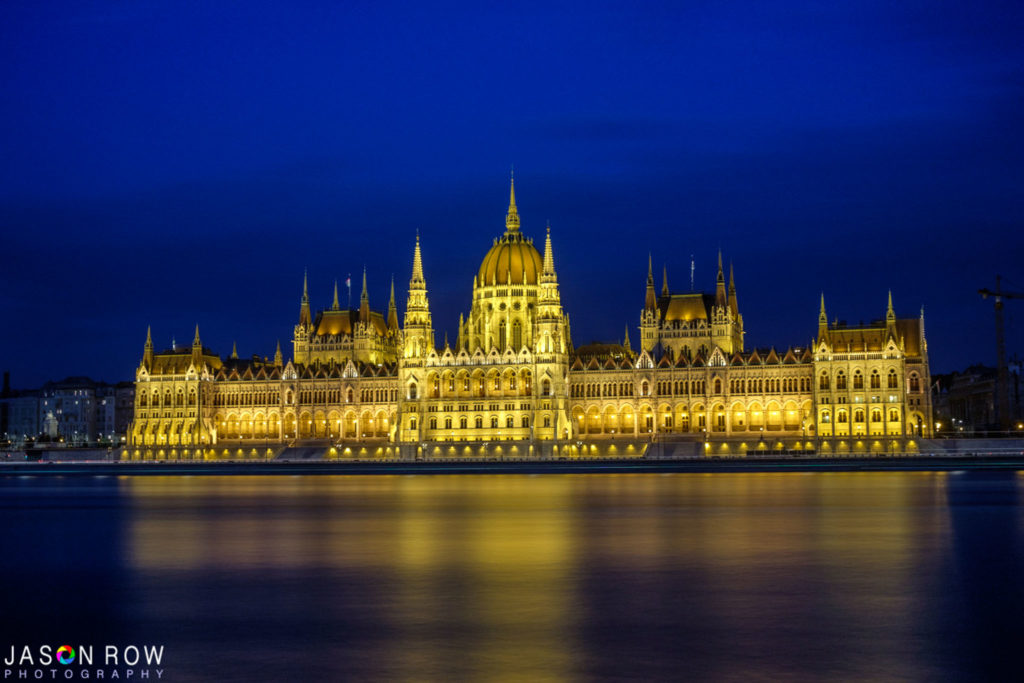 Budapest Parliament building at night as seen from the opposite side of the Danube