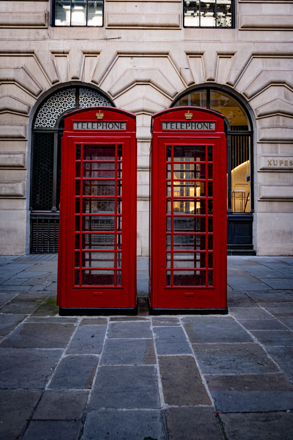 Two red telephone boxes in perfect symmetry in London