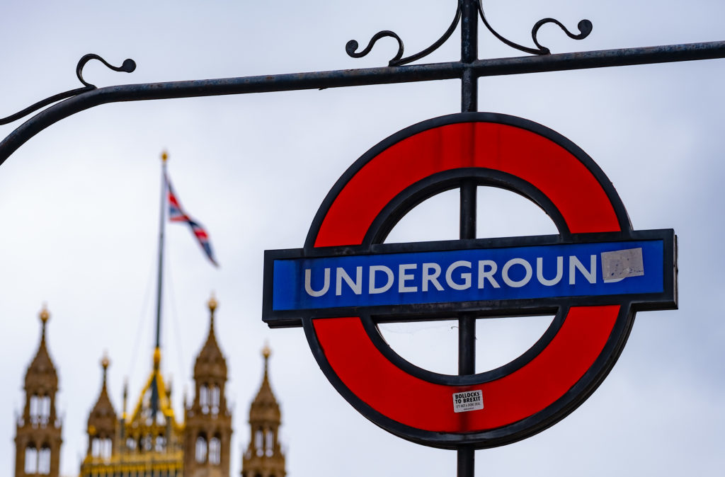London Transport sign with parliament behind.