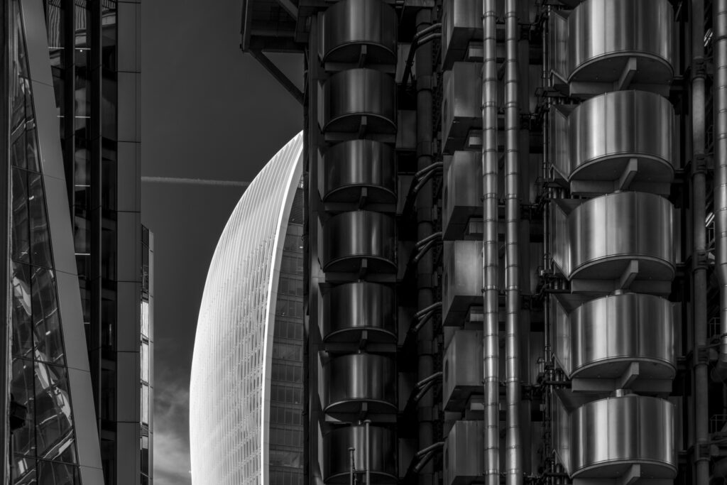 The Walkie Talkie Building seen through a gao between Lloyds of London and Willis Towers Watson on a clear summer day