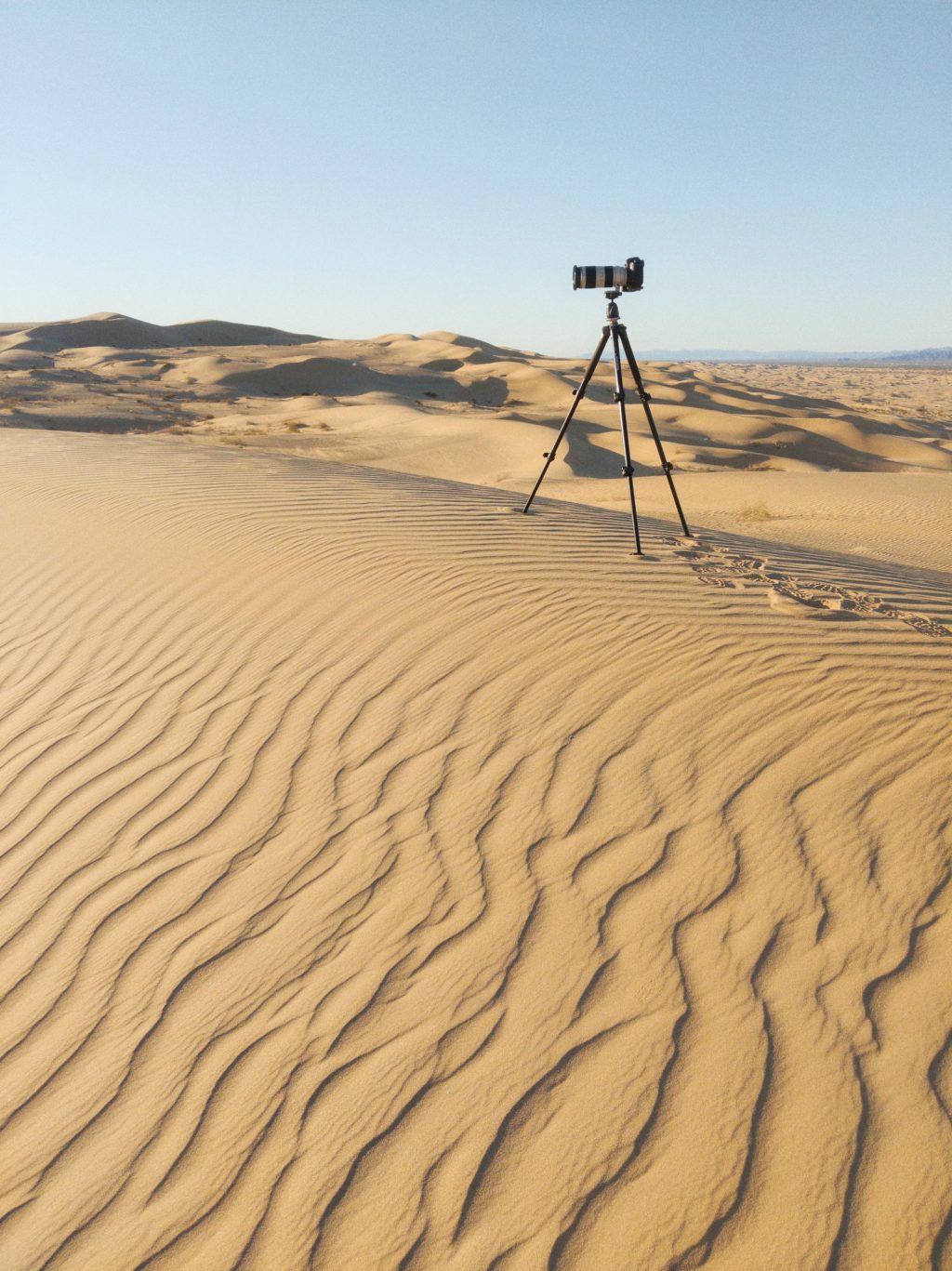 camera gear in front of desert landscape