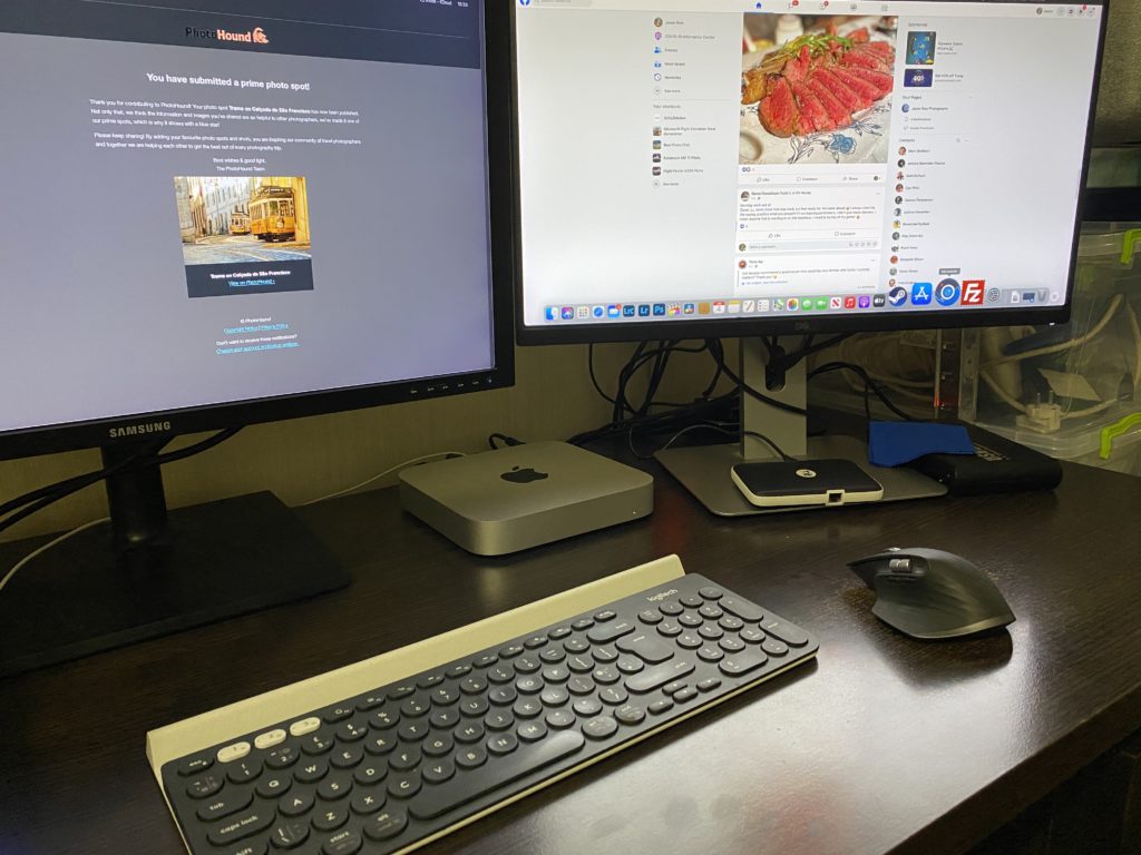 An Apple M1 Mac Mini on desk with two monitors