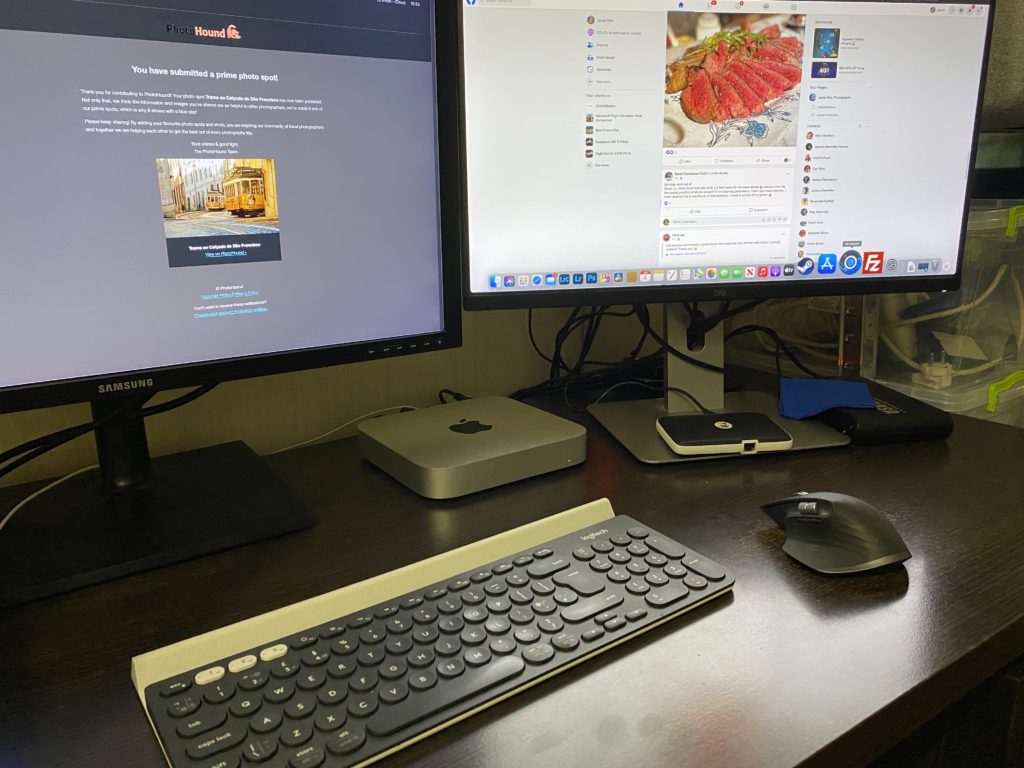 An Apple M1 Mac Mini on desk with two monitors