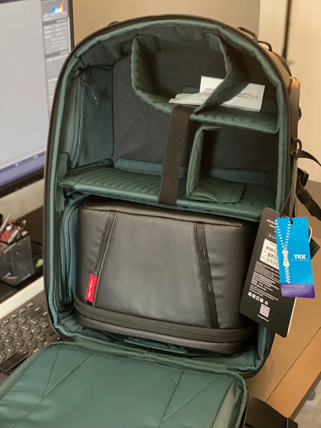 A PGYtech OneMo backpack open on a desk
